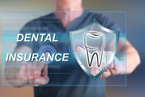 A dentist with “Dental Insurance” and a tooth in front of him