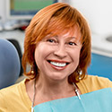 Sparks Dental Services lady with red hair smiling