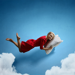 person sleeping on a pillow in the sky