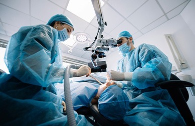 a dentist completing an oral surgery on a patient