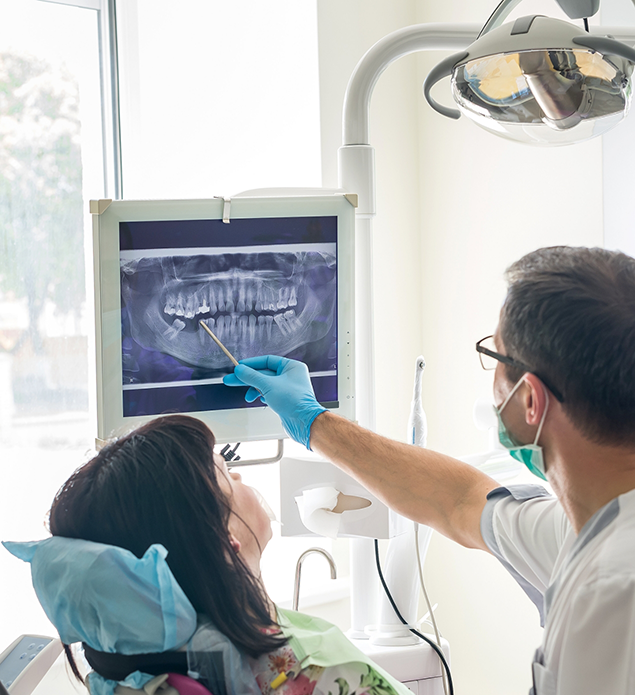 Dentist showing a patient an x-ray of their teeth