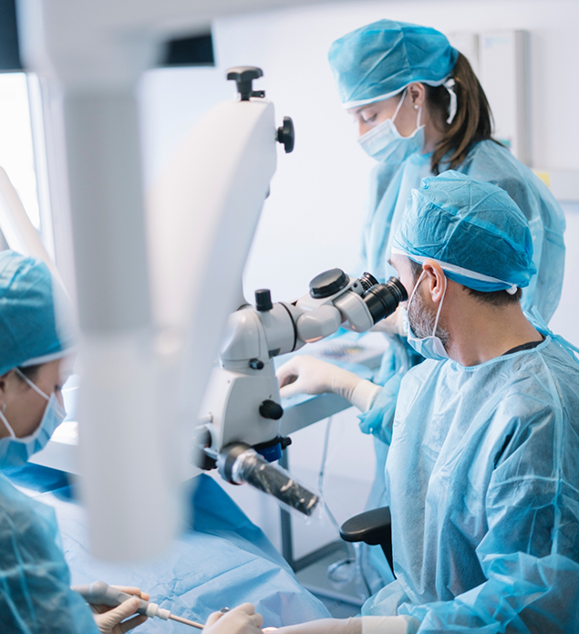Dentist looking into a microscope during a procedure