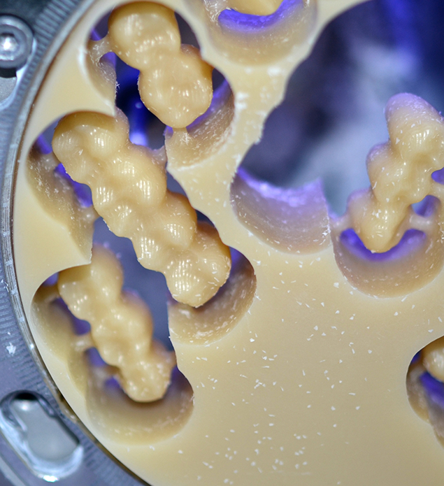 Block of ceramic being molded into dental restorations
