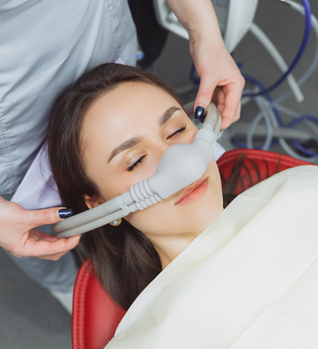 Dental patient with a nitrous oxide mask over her nose