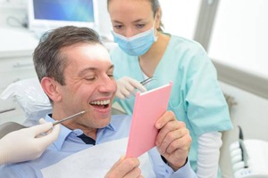 Man looking at smile in mirror