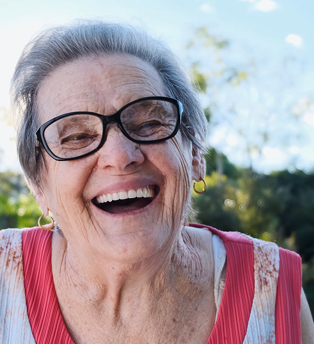Senior woman grinning outdoors