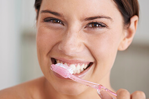 lady merrily brushing teeth