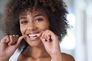 lady enjoying flossing her teeth