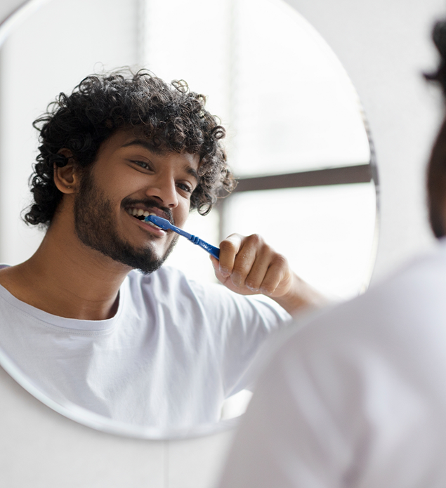 Young man brushing his teeth