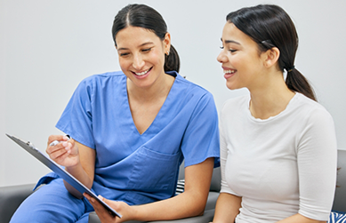 Dental team member showing a clipboard to a patient