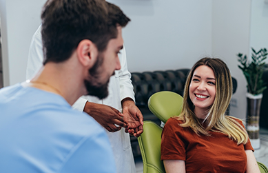 Smiling woman talking to her dentist
