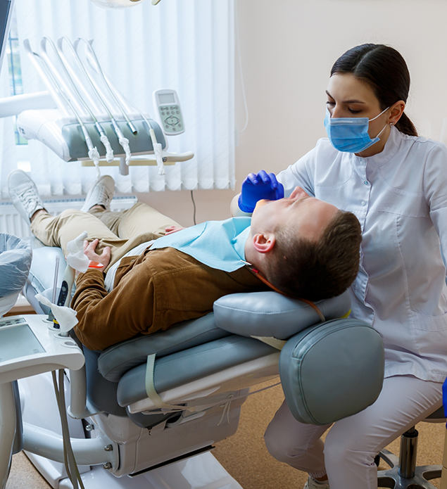 Dentist examining a man's mouth