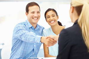 Smiling man and woman discussing dental insurance coverage