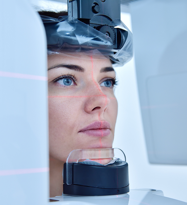 Woman getting a cone beam scan of her face and jaws