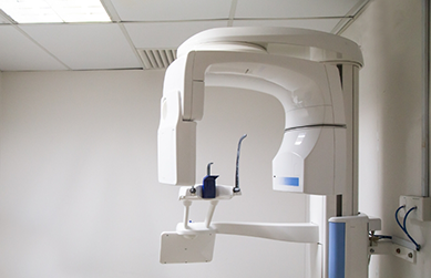 CT cone beam scanning machine standing against a wall