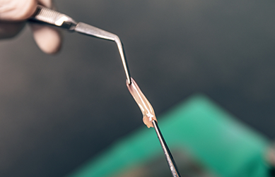 Piece of goopy substance between two scientific instruments