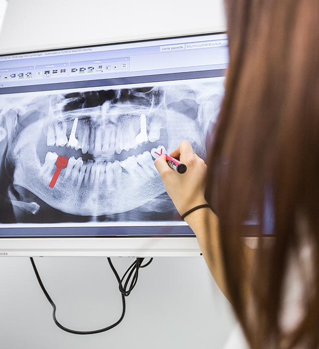Dentist showing a patient an x-ray of their teeth