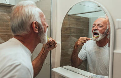 Senior man brushing his teeth
