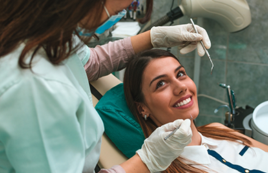 Woman smiling at her dentist during a checkup