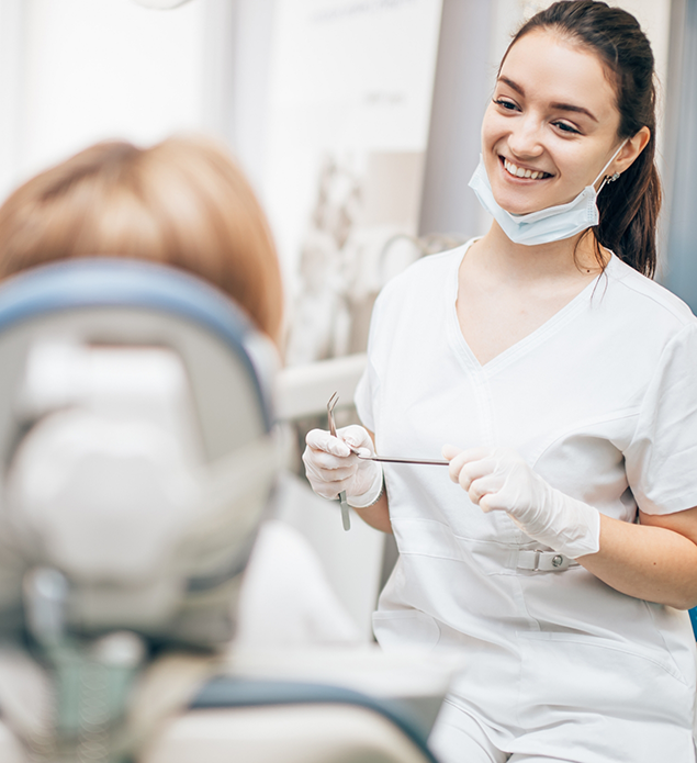 Dental team member grinning at a patient