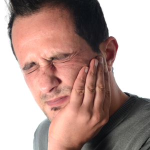 Man in pain holding jaw