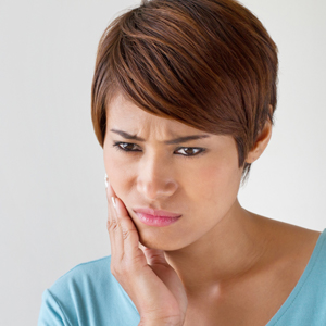 Woman holding jaw in pain