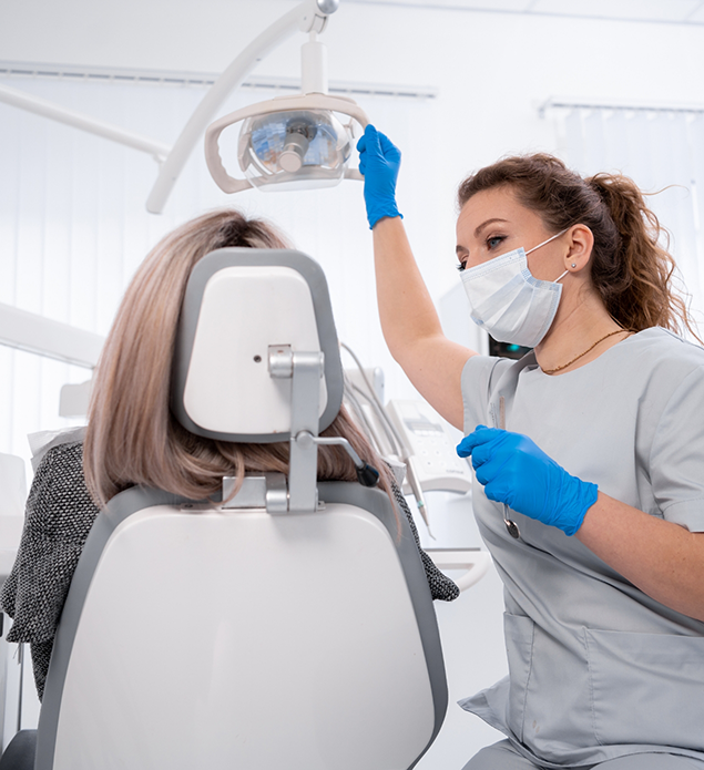 Dentist preparing to examine a patient's teeth
