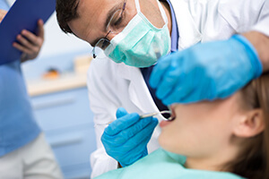Patient in dental chair being treated by dentist