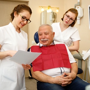 Patient and dental team discussing periodontal treatment options