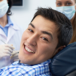 Sparks Restorative Dentistry man on dental chair grinning