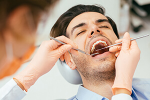 male patient thoroughly examined by dentist