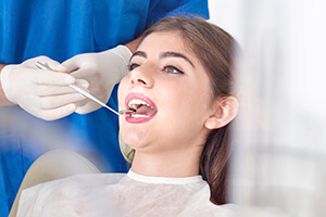 Female patient being treated by the dentist
