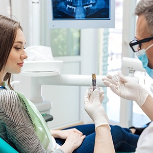 Dentist showing patient implant after dental implant salvage in Sparks, NV