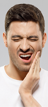 Man holding the side of his jaw in pain
