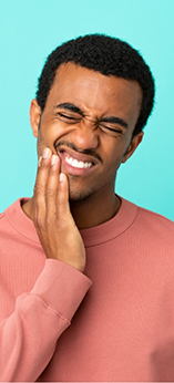 Man holding his cheek in pain