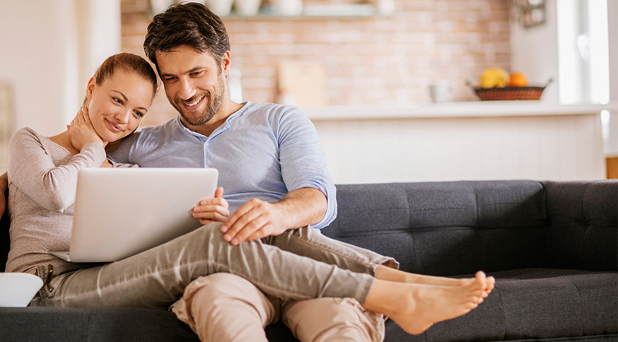 intimate couple sharing a laptop