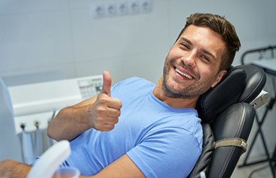 Young man giving a thumbs up in the dental chair
