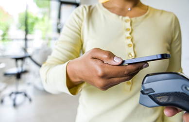 Woman scanning her phone to pay