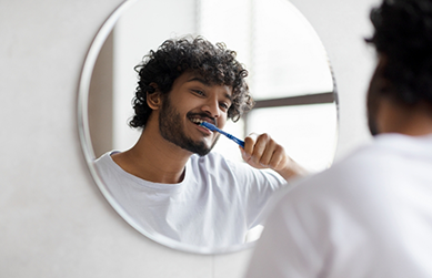Young man brushing his teeth