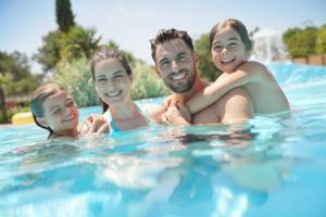 happy family swimming in a pool 