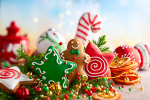 Gingerbread cookies surrounded by holiday decorations