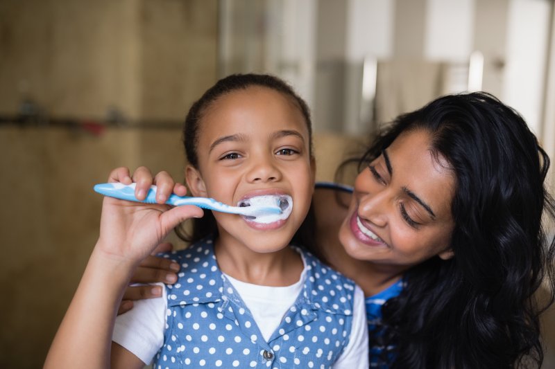 A family brushing in the mirror