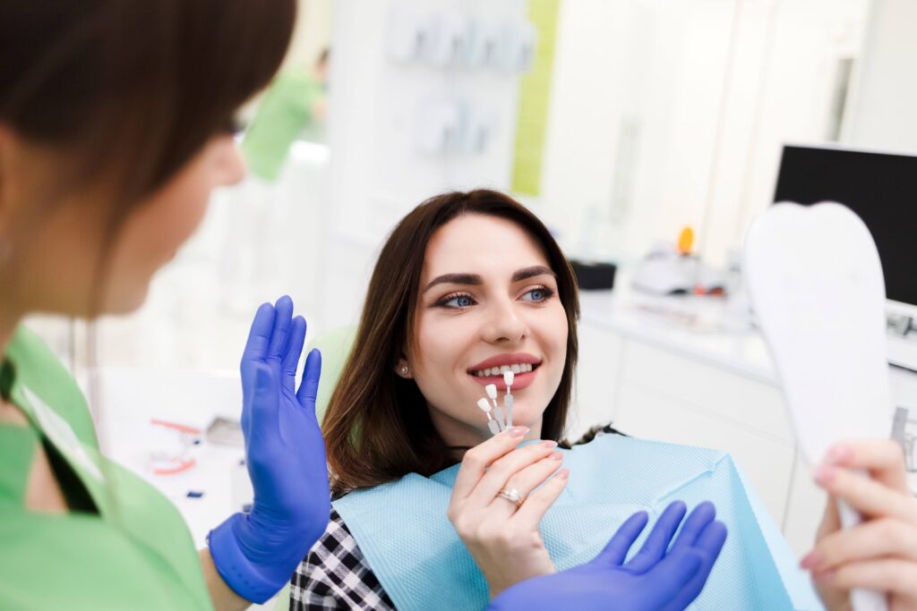 Smiling patient choosing shade of veneer