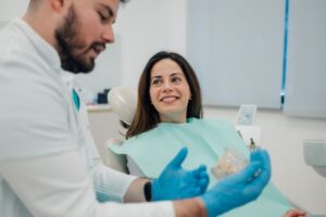 Young woman learning about how dentures can benefit her