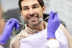 Man smiling after avoiding dental implant failure