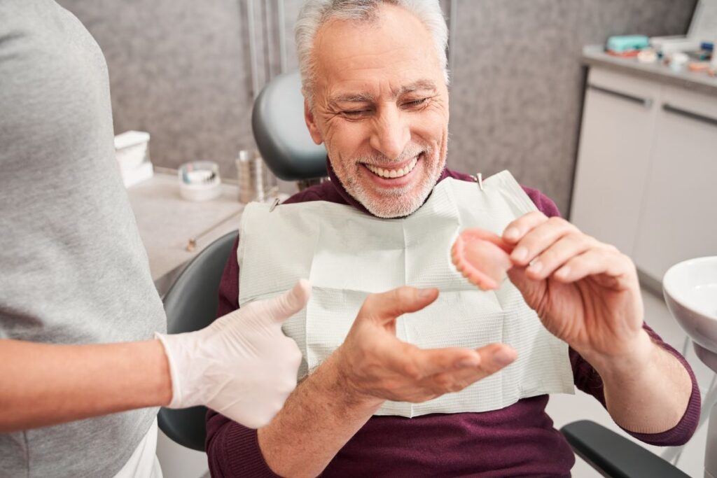 A man having his dentures checked at the dentist.
